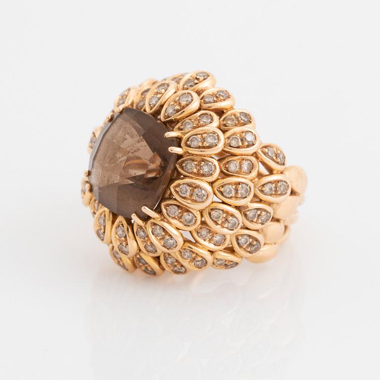 An 18K gold and smoky quartz ring set with round brilliant-cut diamonds.