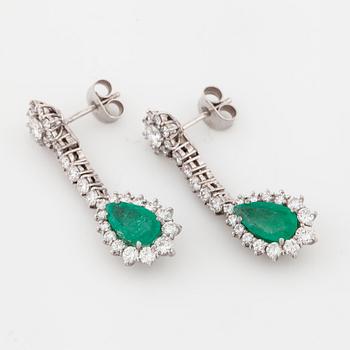 A pair of pear cut emerald and brilliant cut diamond earrings.
