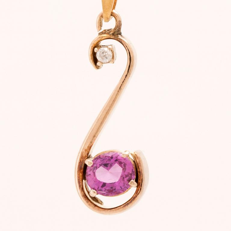 Pendant in 18K gold with an oval faceted pink sapphire and a round brilliant-cut diamond.