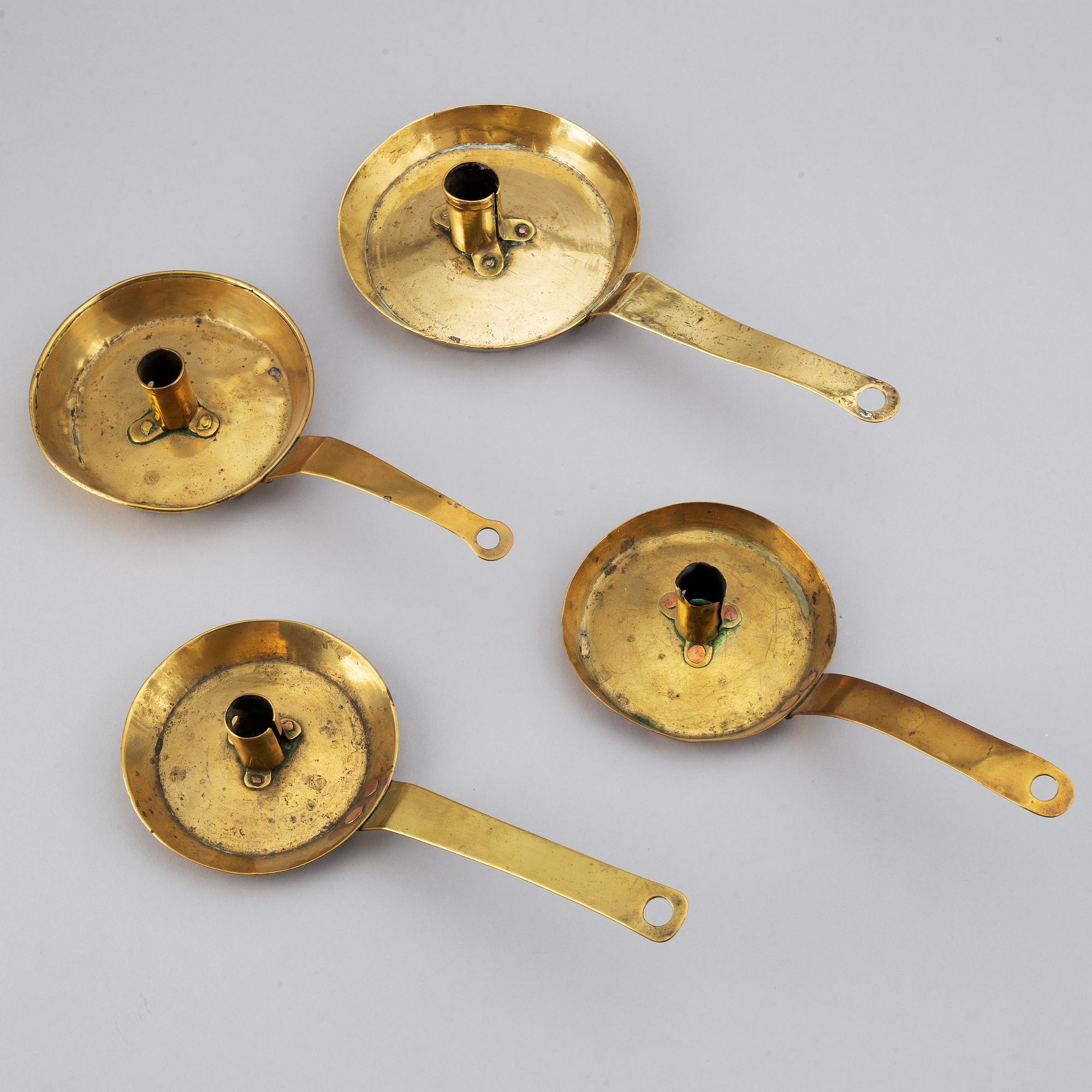 Four 18th century brass night light holders.