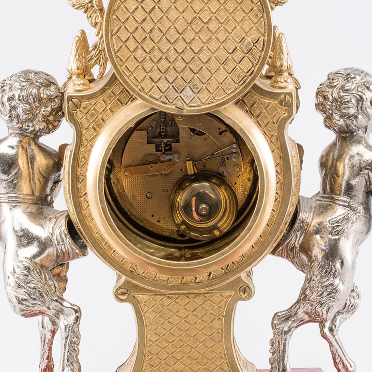 A Franz Hermle mantel clock and a pair of chandelabras. mid/2:nd half of the 20th century.