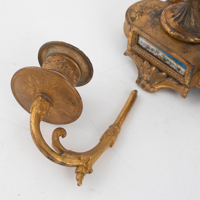 A pair of candelabras and a mantel clock, late 19th Century.