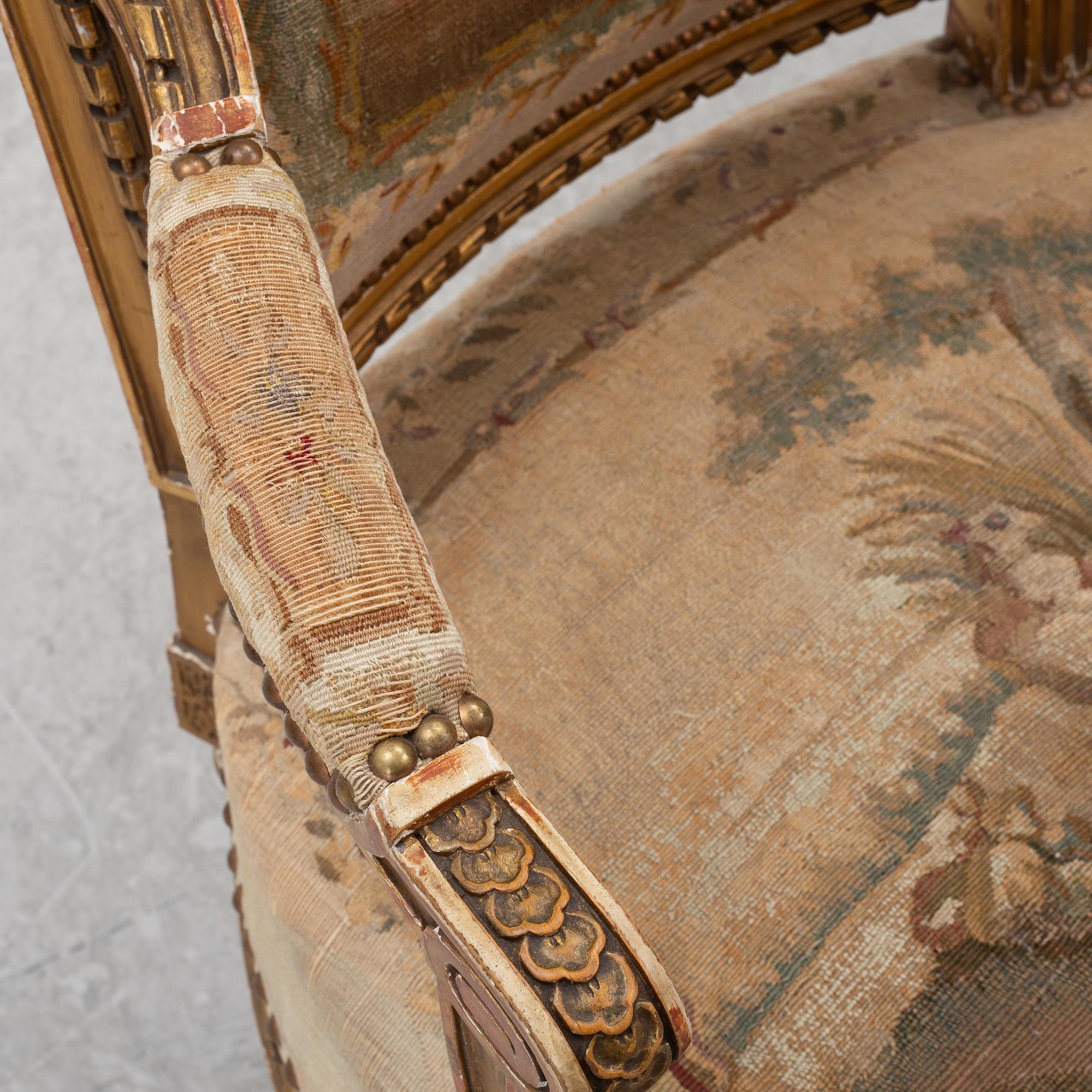 A pair of Louis XVI-style armchairs, late 19th century with 18th century fabric.