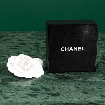 A Brooch by CHANEL.