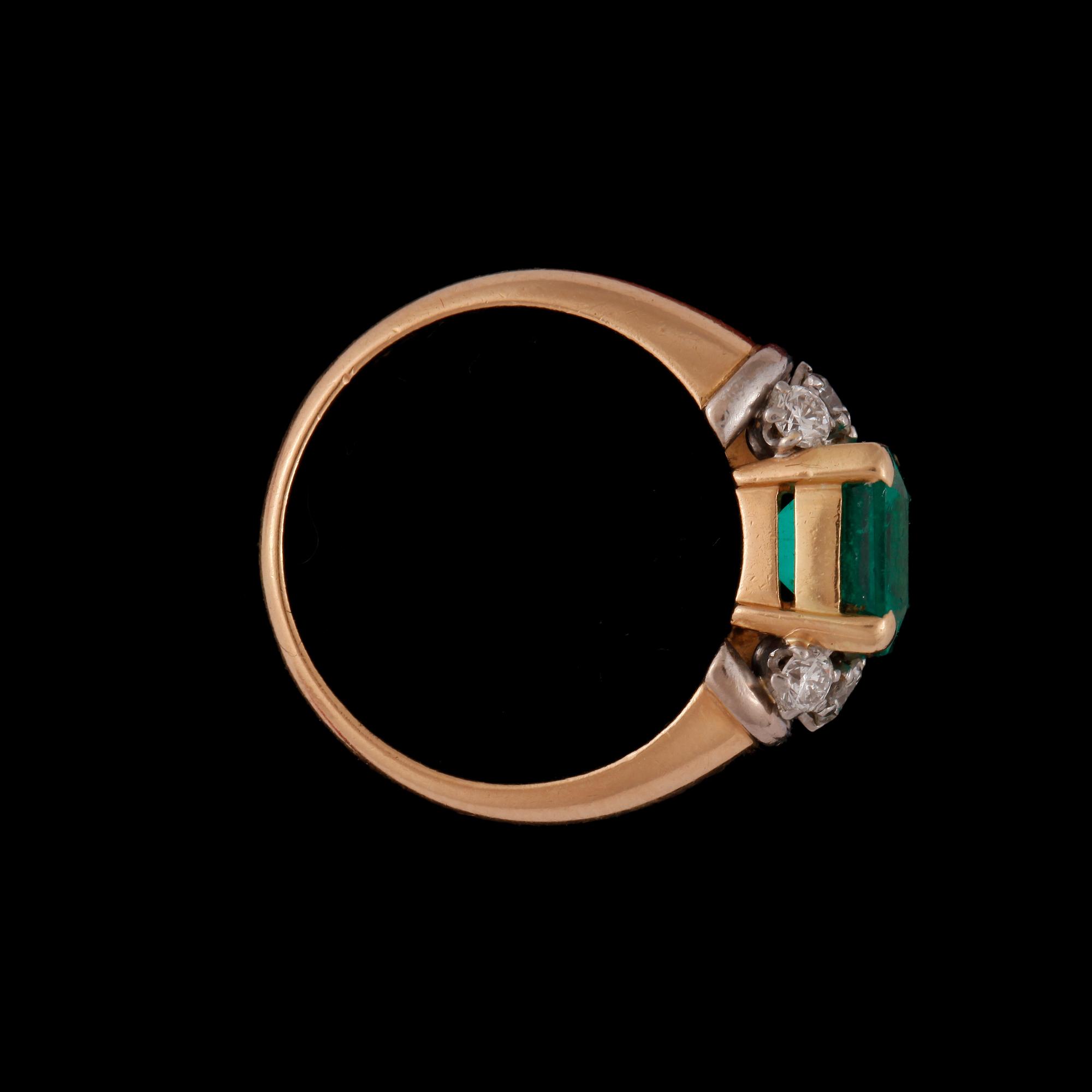 A emerald and diamond ring.