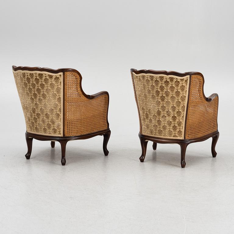 A pair of rococo style armchairs, first half of the 20th century.