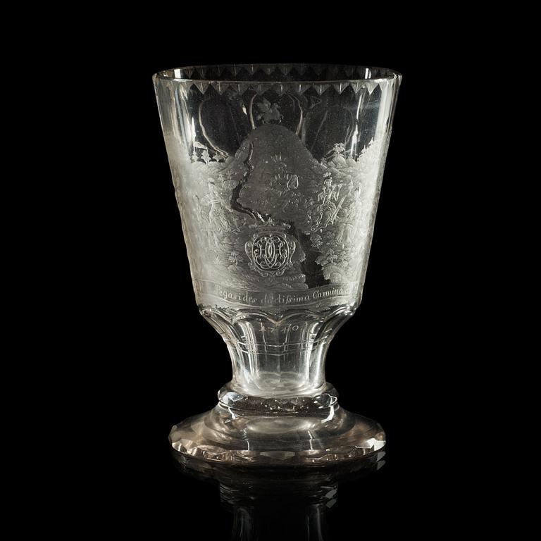 A cut and engraved glass beaker, dated 1740.