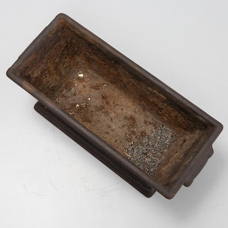 A cast iron plant pot, 20th Century.
