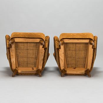 A pair of mid-20th-century armchairs.