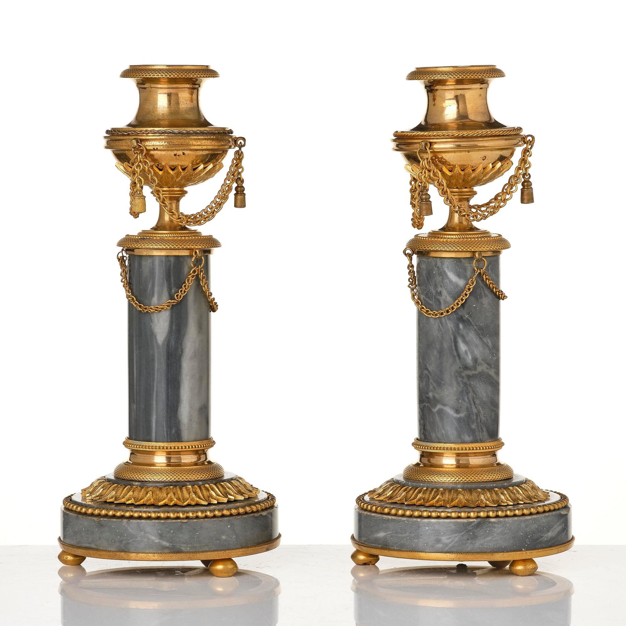 A pair of Louis XVI ormolu and Bleu turquin candlesticks.