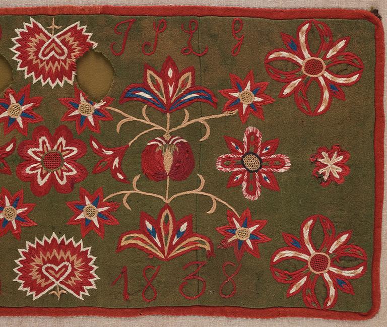 An embroidered carriage cushion, ca 51 x 113 cm (with mounting 61 x 122 cm) signed and dated END JPLG ANO 1838, Scania.