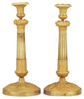 684. A pair of French Empire early 19th Century candlesticks.