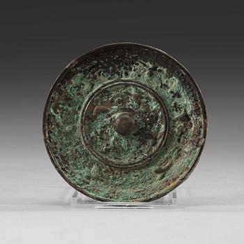 96. A bronze mirror decorated with flying birds, Tang dynasty (618-907).