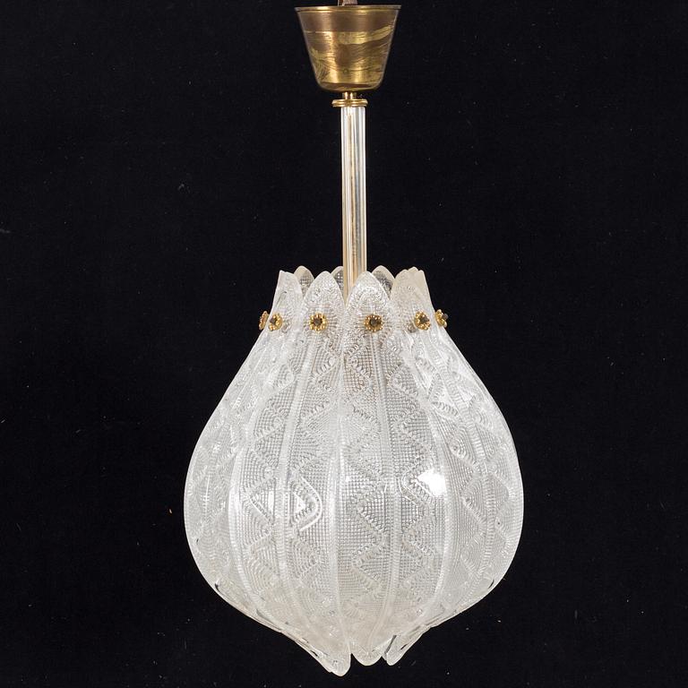 A GLASS AND BRASS CEILING LAMP DESIGNED BY CARL FAGERLUND FOR ORREFORS.