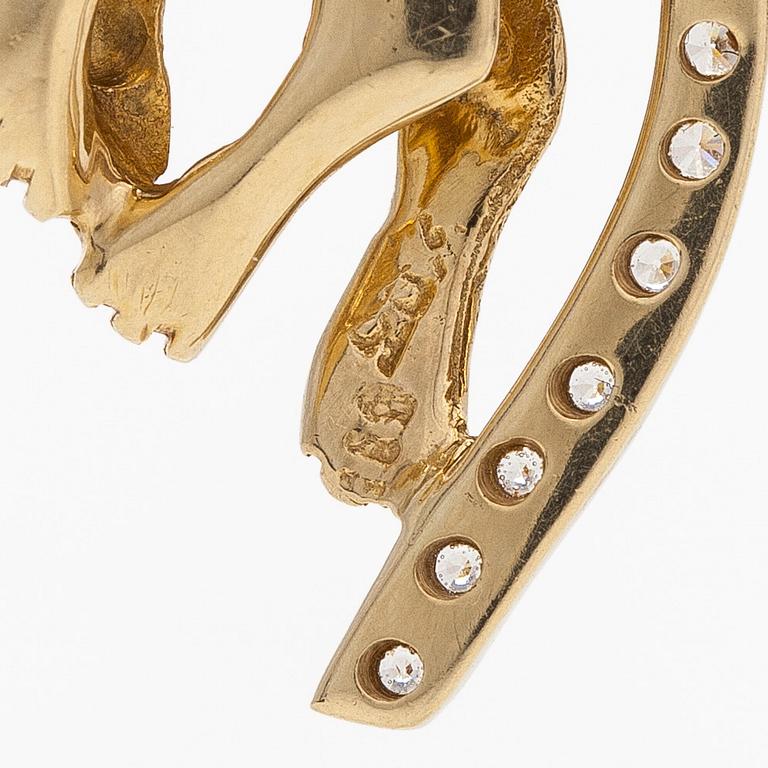 A 14K gold necklace with a panther pendant set with white stones.