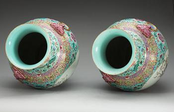 A large pair of turquoise ground famille rose vases, early 20th Century with Qianlongs sealmark.