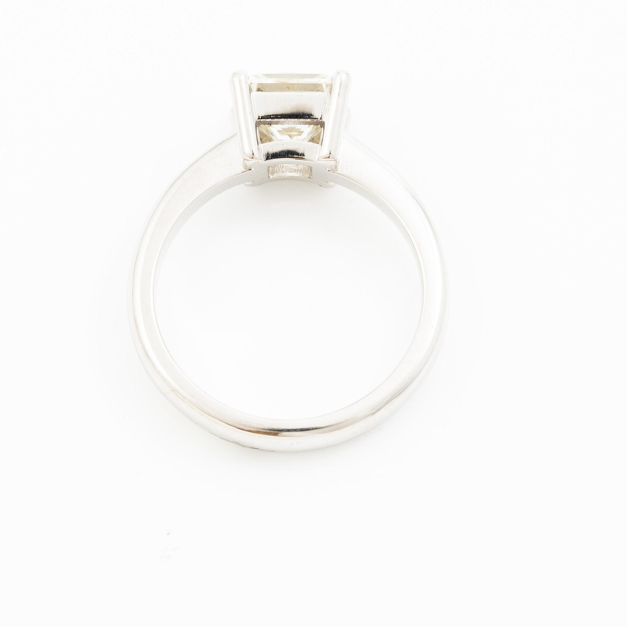 A ring in 18K gold with a princess-cut diamond.