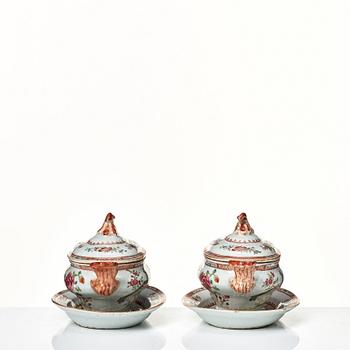 Two famille rose 'double peacock' butter tureens with covers and stands, Qing dynasty, Qianlong (1736-95).