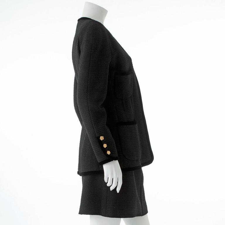 CHANEL, a two-piece suit consisting of jacket and skirt.