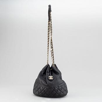 Chanel, a black leather drawstring bag.