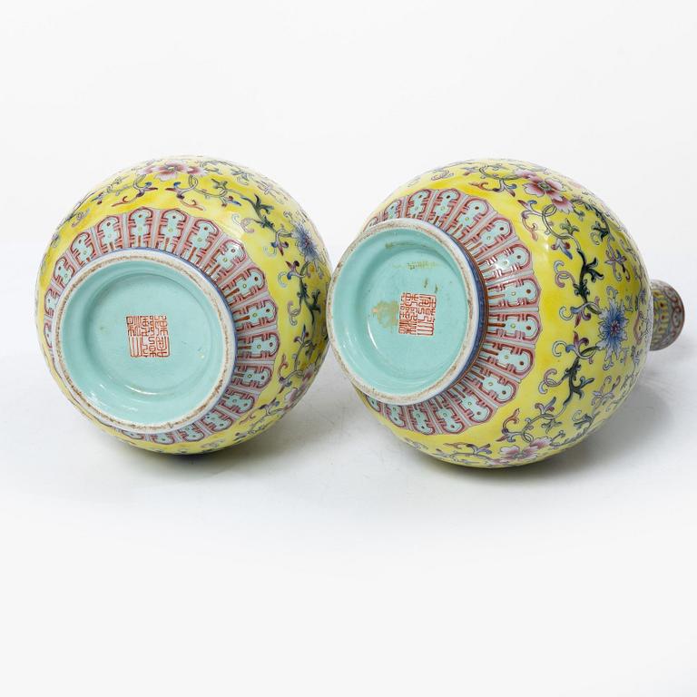A pair of Chinese yellow ground porcelain vases, 1900s.