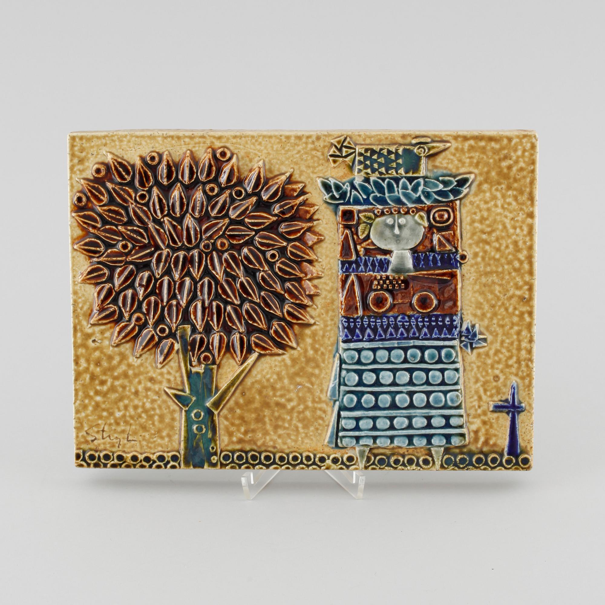 A stoneware wall plaque by Stig Lindberg, signed in the ceramics.