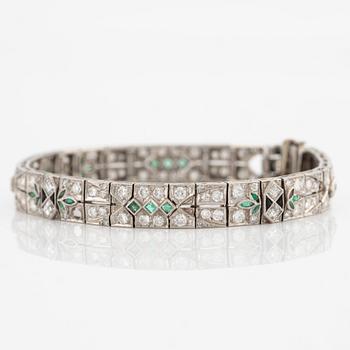 Bracelet in platinum set with round brilliant-cut, eight and step-cut diamonds, emeralds and onyx.