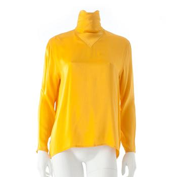 795. GUY LAROCHE, a yellow silk blouse.