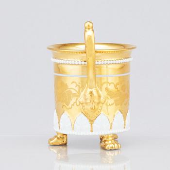 A gilded French Empire cup with stand, 19th Century.