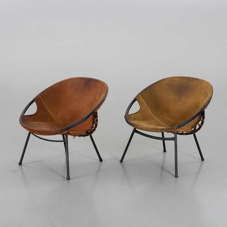 A pair of 1960s-70s steel and leather easy chairs.