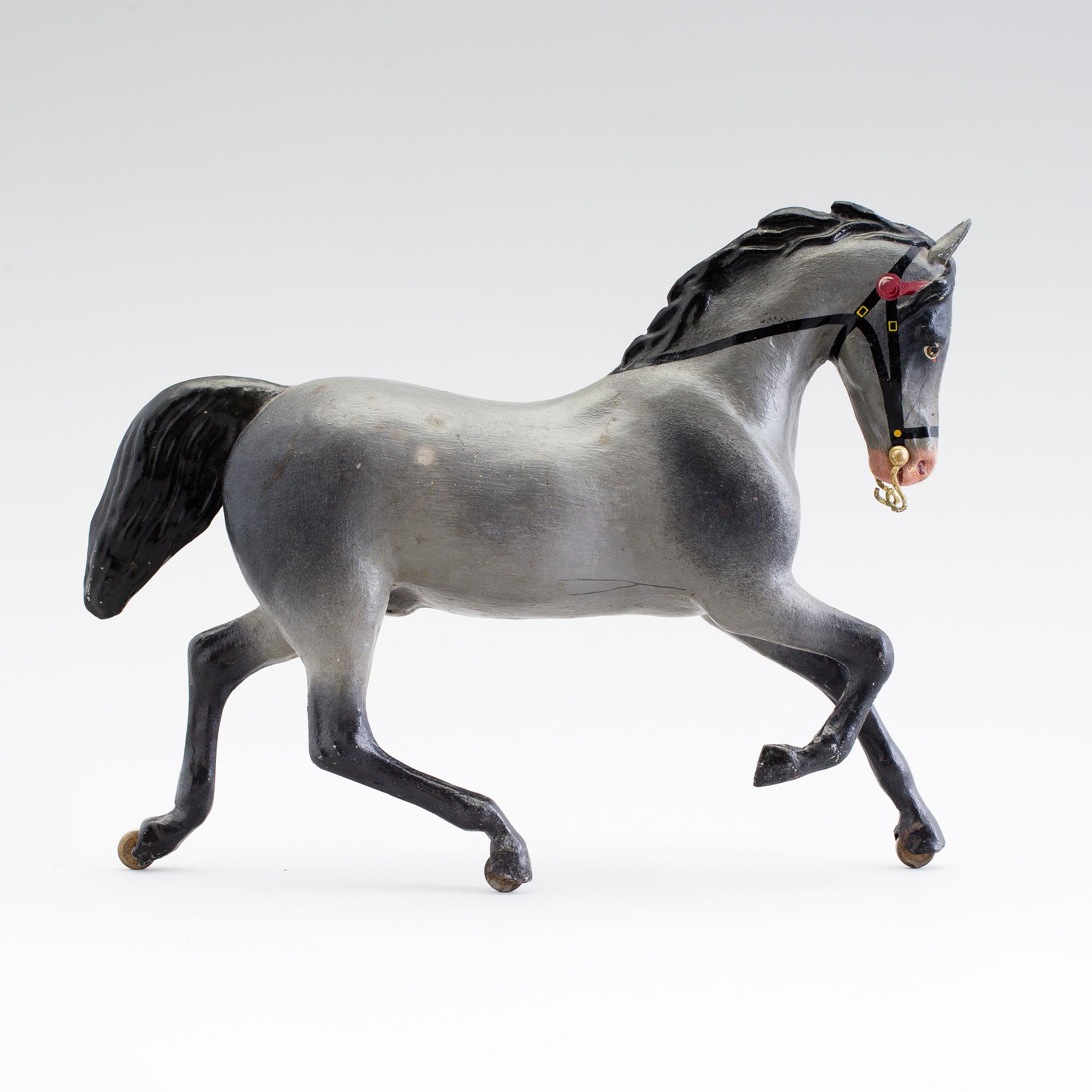 A painted tinplate toy horse ca year 1900.