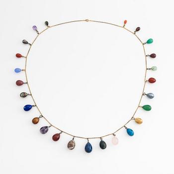 Necklace with jeweled egg, 14K gold and metal.