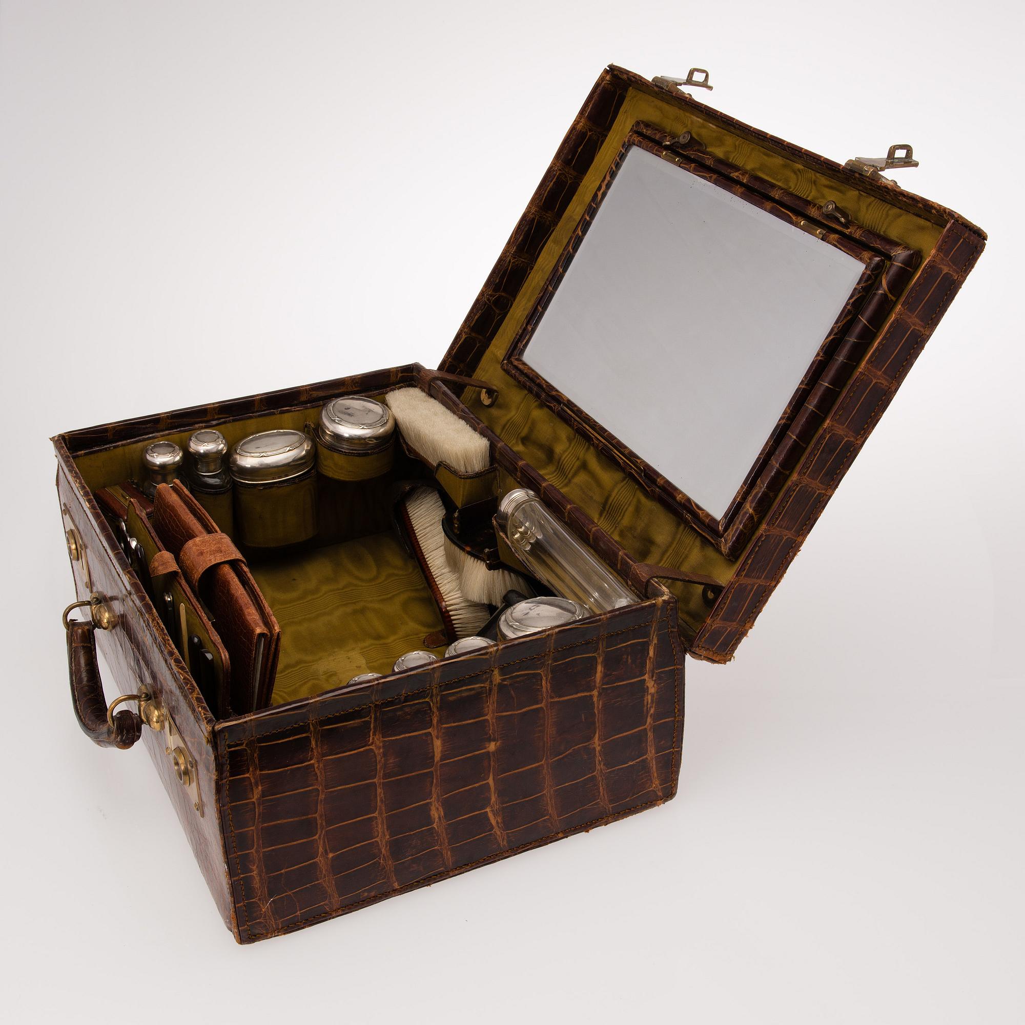 A TRAVEL TOILET CASE, leather, German 1910-20s, boxes with silver lid.