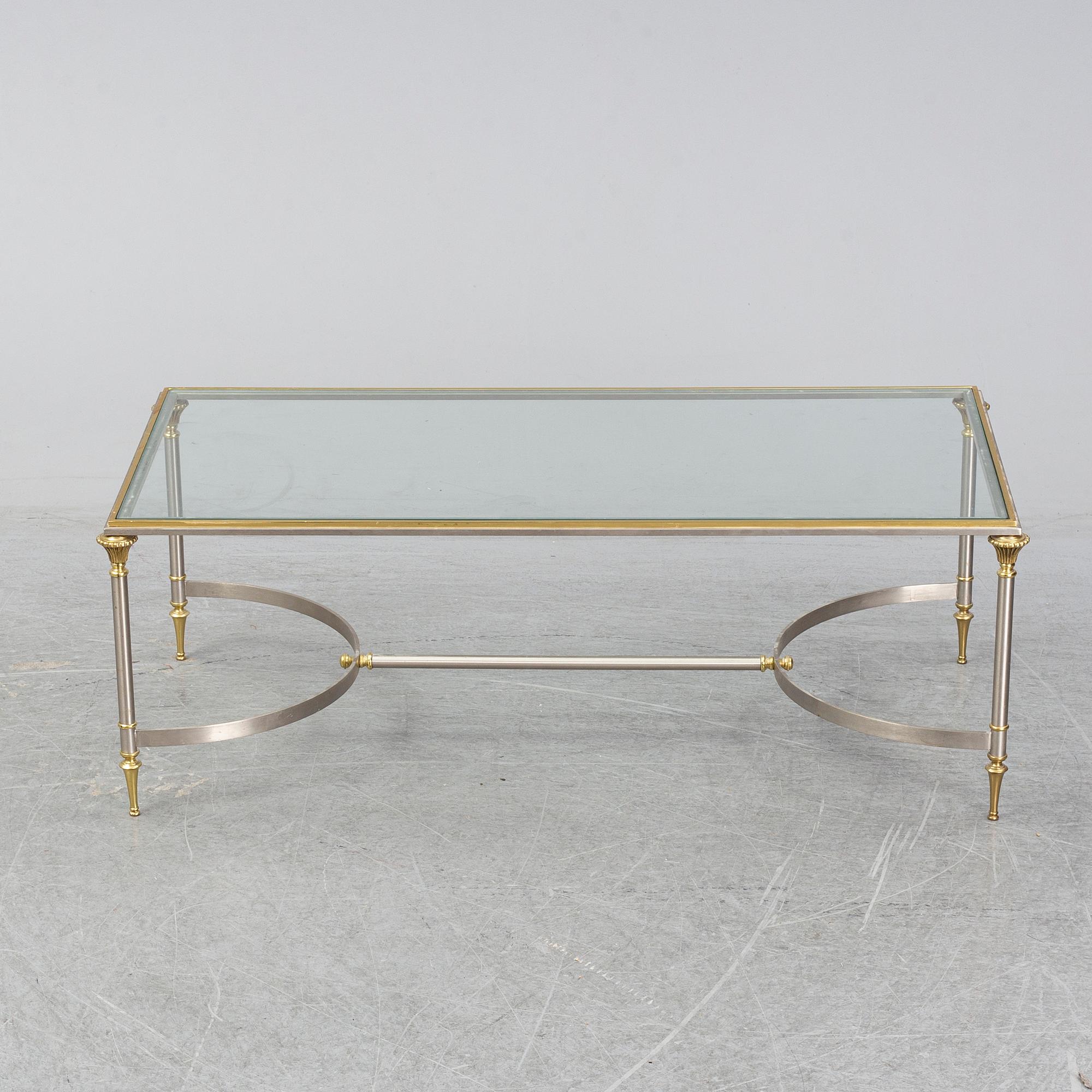 A 1970s sofa table, brass and glass.