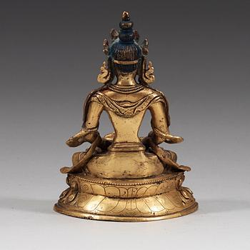 A seated Sino-Tibetan gilt bronze figure of Amitauys, 18th Century.