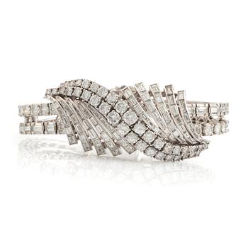 555. A platinum bracelet set with round brilliant- and baguette-cut diamonds.