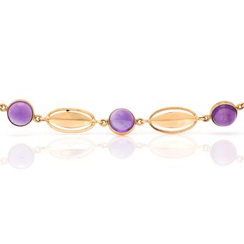 A bracelet with round, cabochon-cut amethysts.