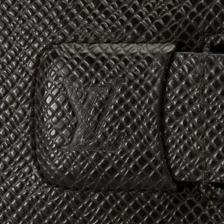 A Louis Vuitton palm pilot leather cover.