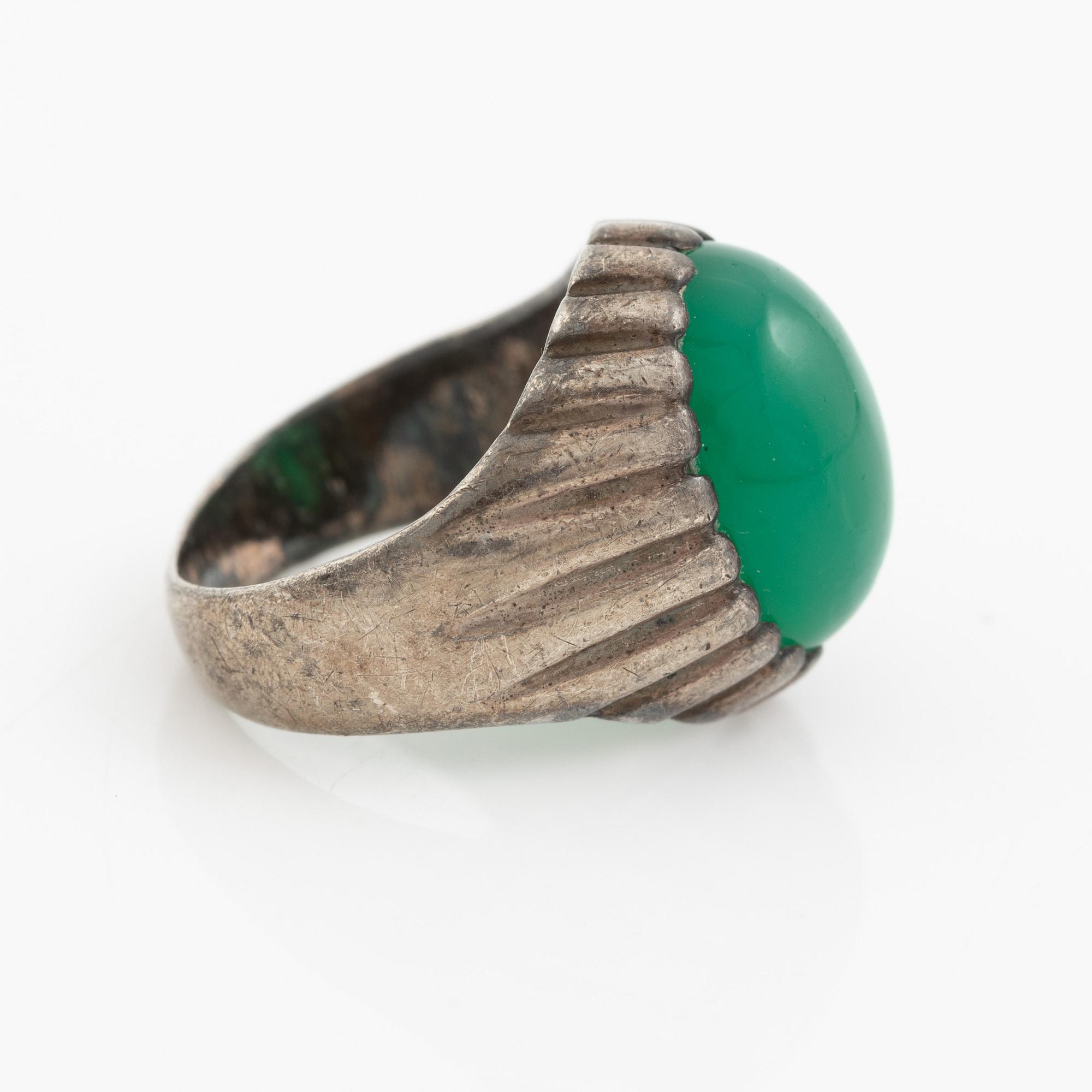 Silver ring with a green cabochon-cut stone.