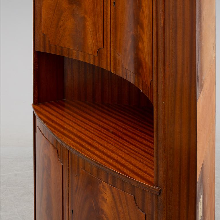 a mahogany corner cabinet.