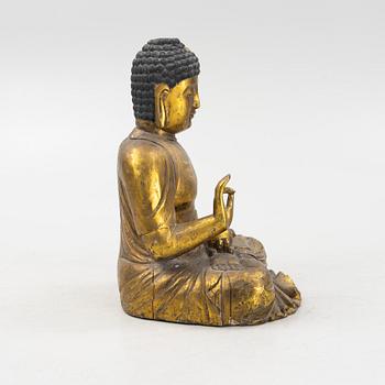 A massive gilded wooden figure of buddha, 20th century.