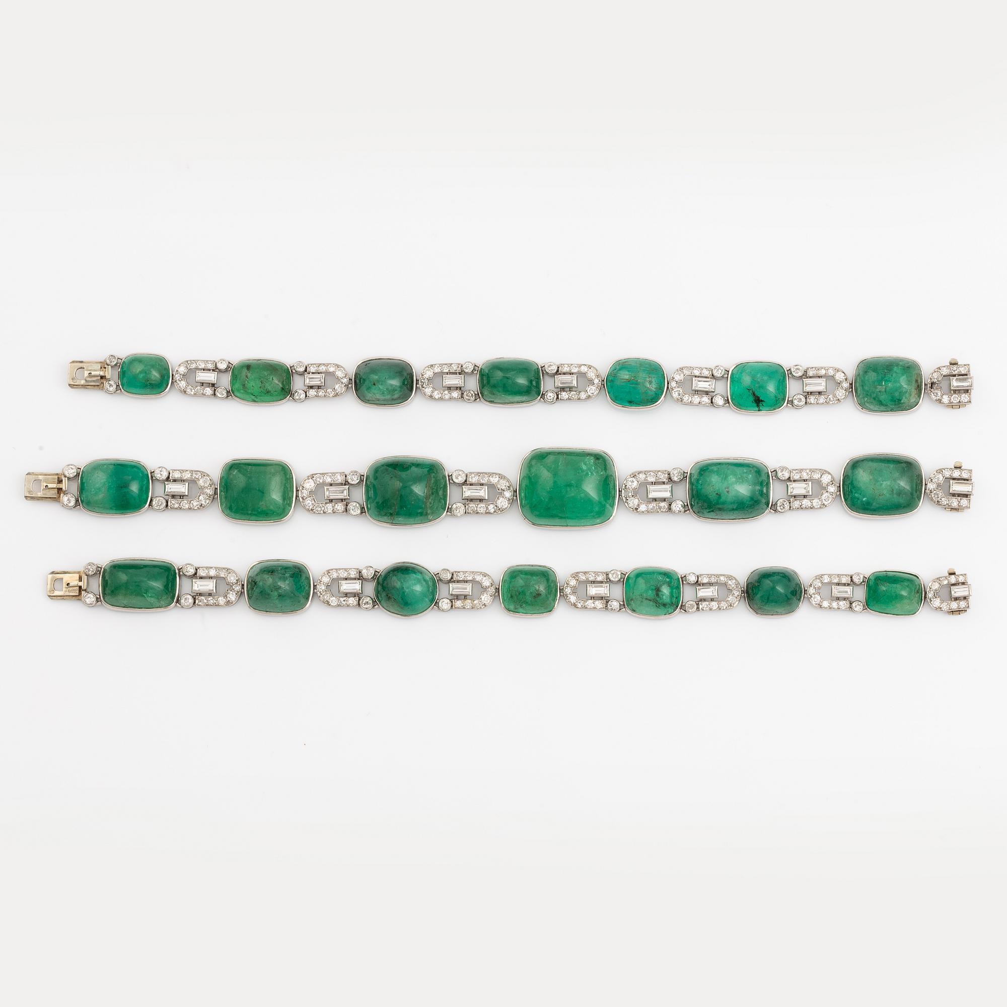 An art deco platinum necklace/bracelet combination with cabochon-cut emeralds.