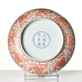 An iron red decorated 'lotus' dish, Qing dynasty, with a Kangxi six character mark and of the period (1662-1722).