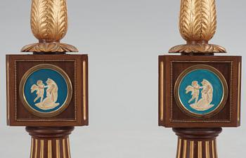 A pair of Empire 19th century candle stands.