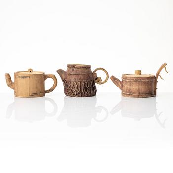 A group of three bright yellow yixing 'Gongfu' teapots, China, 1990s.