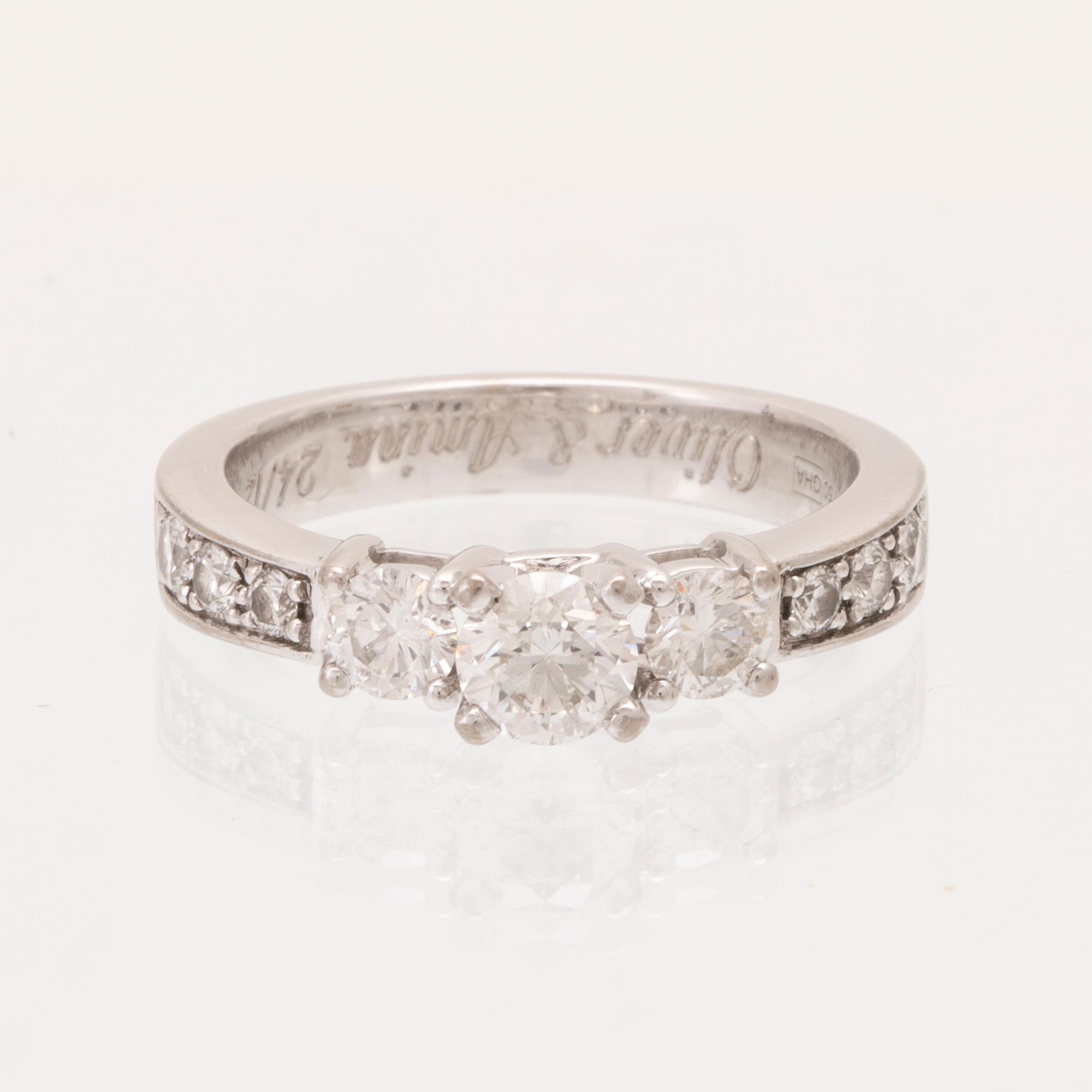 An 18K white gold ring set with round brilliant cut diamonds.