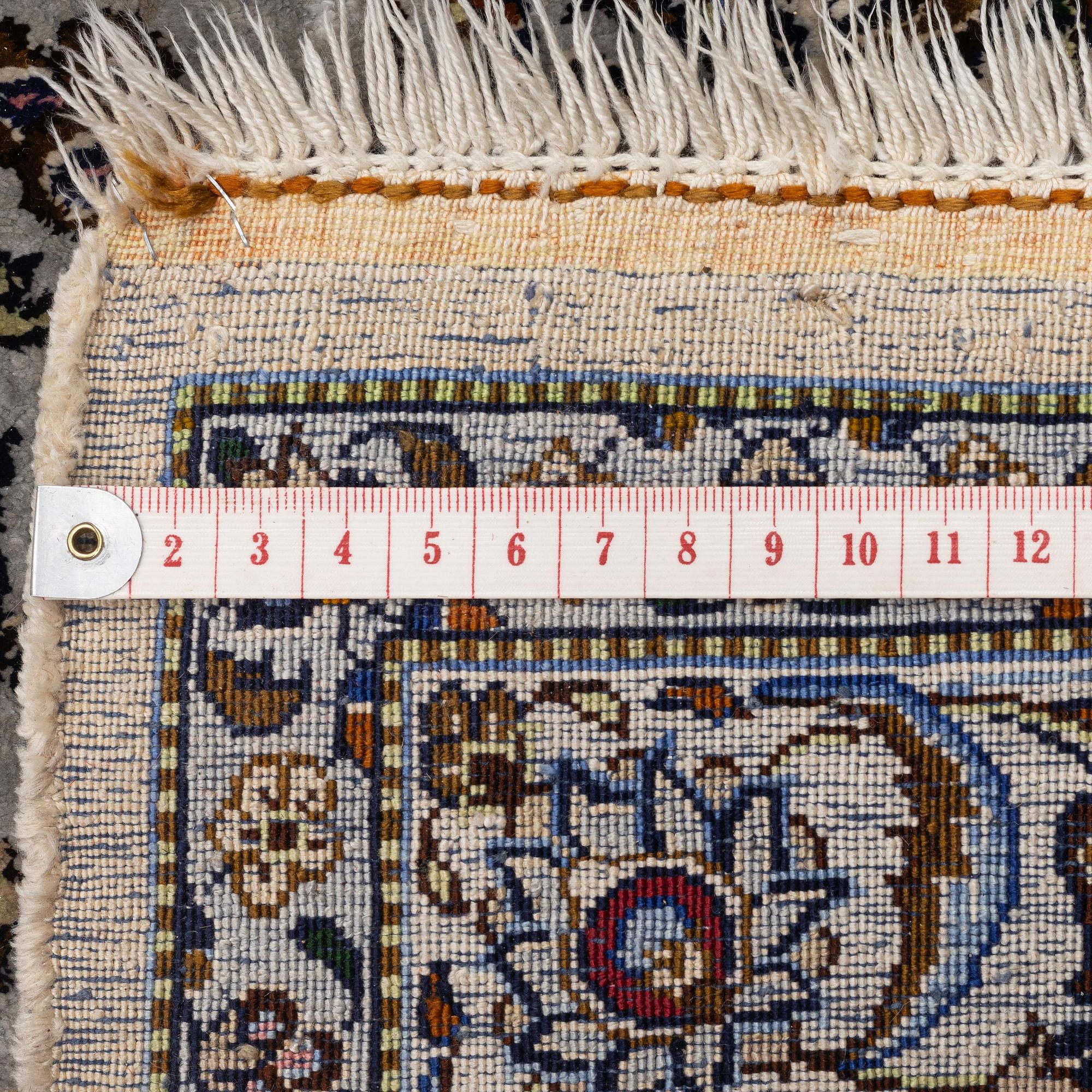 A semi-antique silk Keshan carpet, c. 350 x 248 cm.