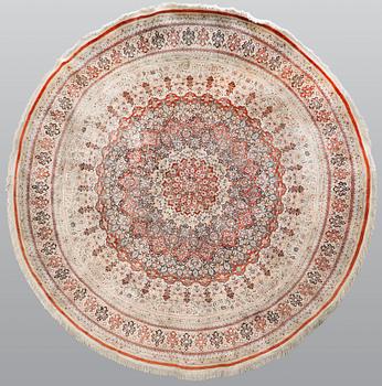 An Oriental silk rug, diameter 256 cm.