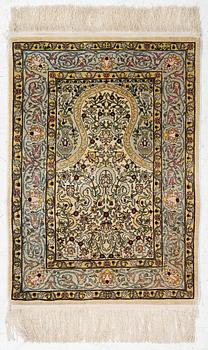 A silk Hereke rug, Turkey, approx. 82 x 58 cm.