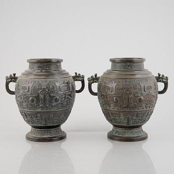 A pair of Chinese bronze urns, 20th century.